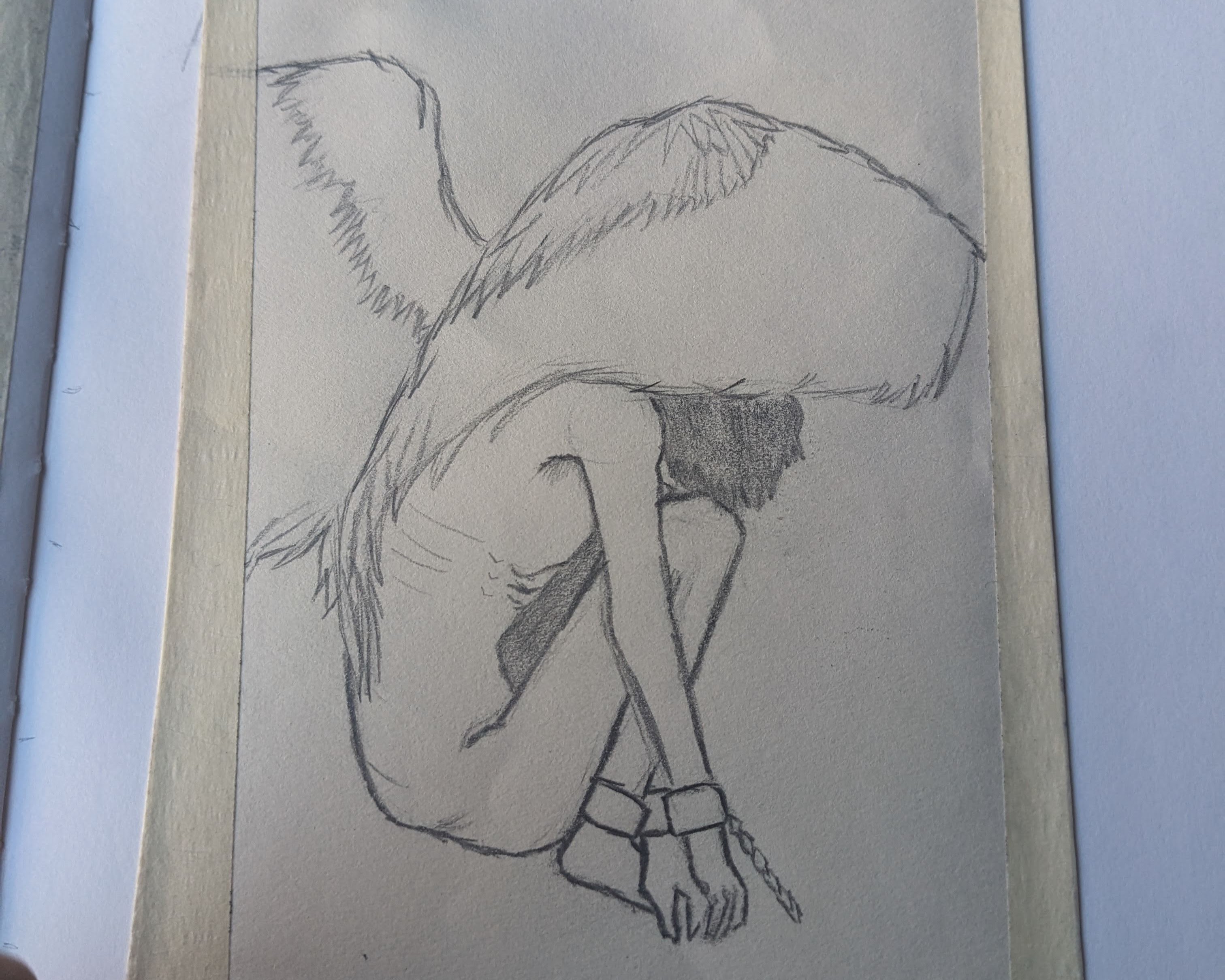 Sketched of a chained angel sitting down